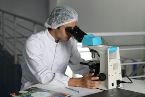 A Scientist using a Microscope